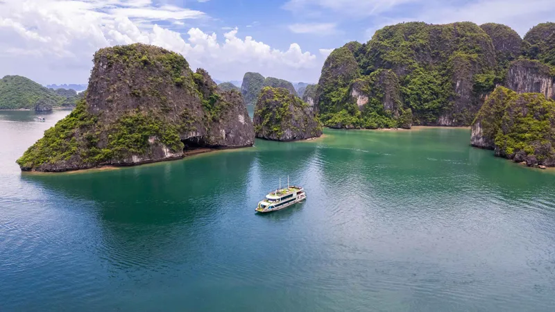 Day boat among limestone karsts on a Ha Long Bay junk boat cruise from Hanoi, Vietnam