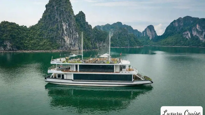 Luxury day cruise boat on calm water during a Ha Long Bay junk boat cruise from Hanoi, Vietnam