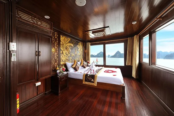 Wood-panelled Deluxe Seaview Cabin on the Renea boat during a Ha Long Bay junk boat cruise to Bai Tu Long Bay, Vietnam