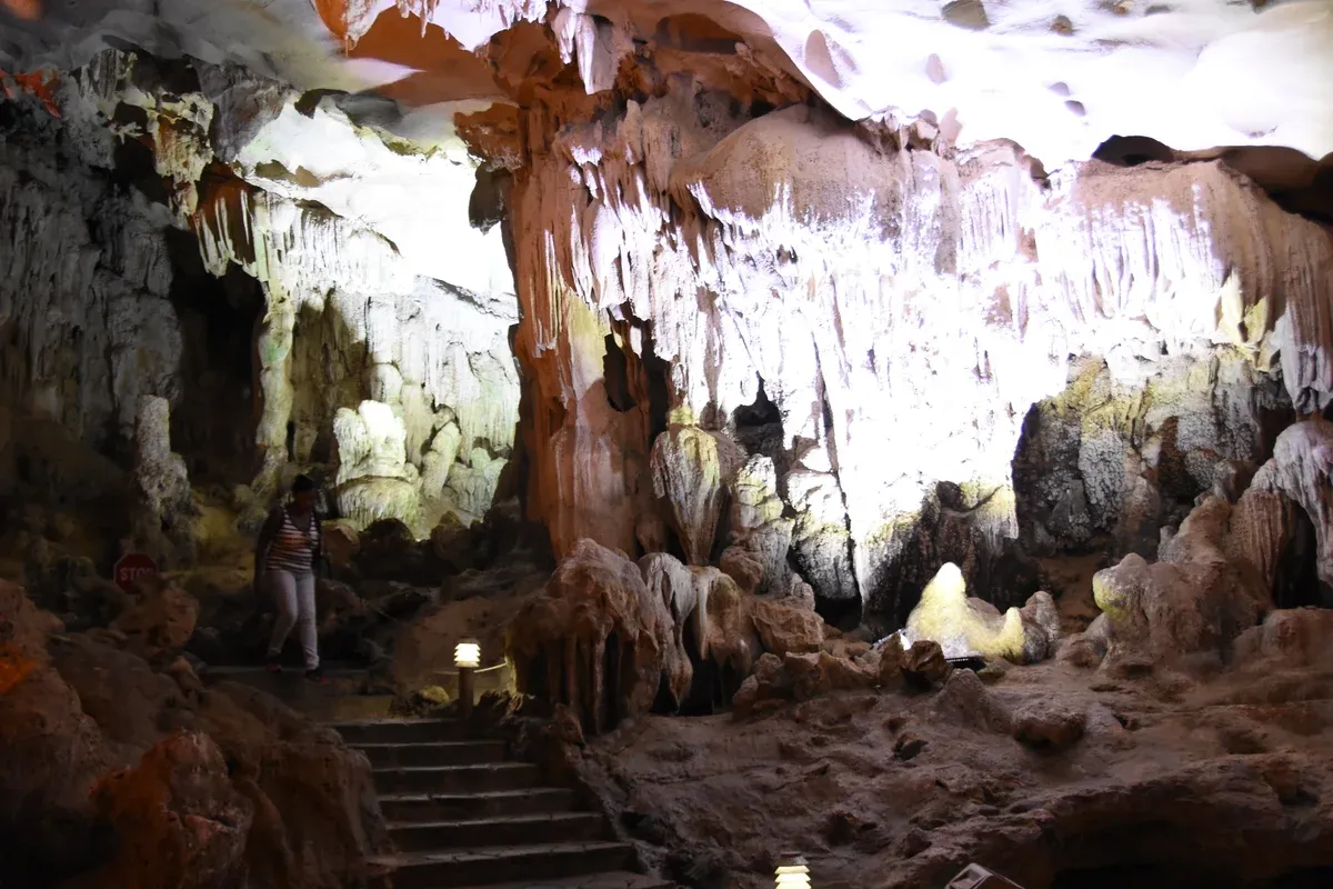 Lit walkway with steps inside Sung Sot Cave on a Ha Long Bay junk boat cruise