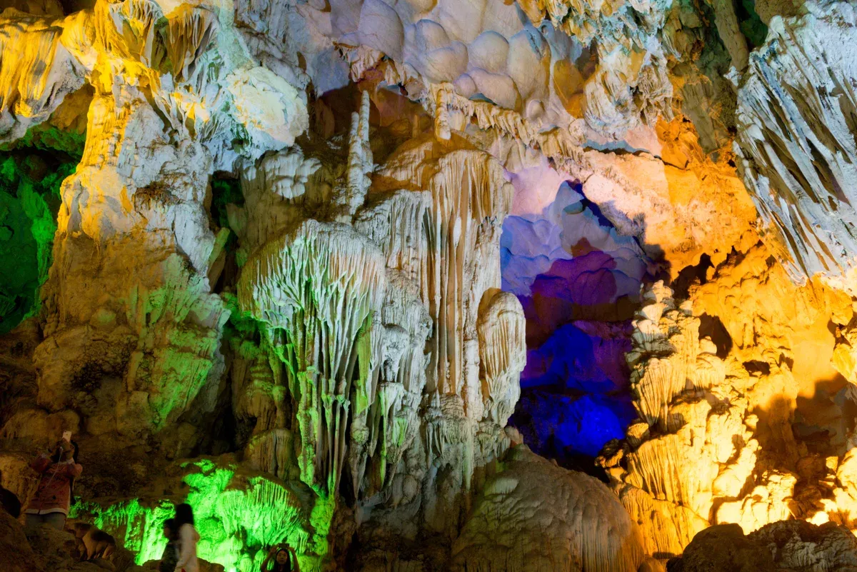 Coloured lighting on the formations in Thien Cung Cave, visited on a Ha Long Bay junk boat cruise