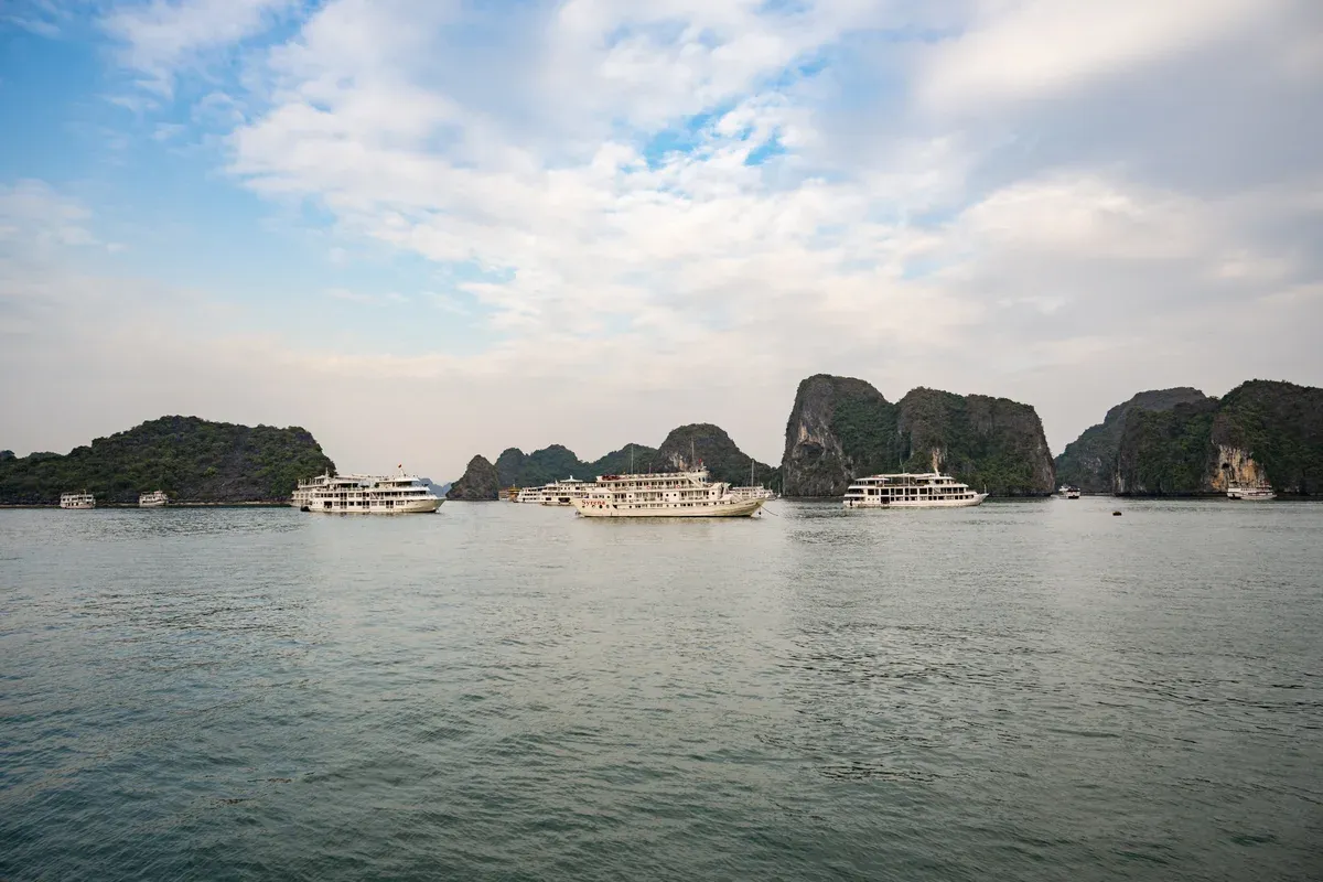 Ti Top Beach with cruise boats anchored beyond it on a Ha Long Bay junk boat cruise